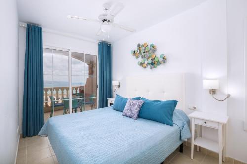 a bedroom with a bed and a view of the ocean at Casa Storm in Costa Calma