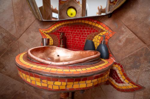 a bathroom with a sink in a mosaic wall at Casa Primal in San José de Maipo