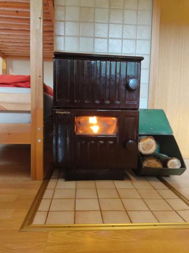a kitchen with a stove in a room at Gasthaus Piesau - Thüringer Wald - Rennsteig in Piesau