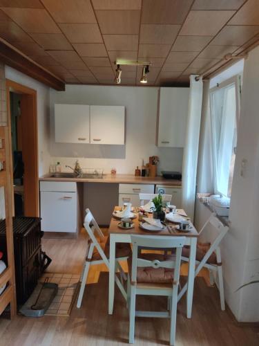 a kitchen with a table and chairs in a room at Gasthaus Piesau - Thüringer Wald - Rennsteig in Piesau