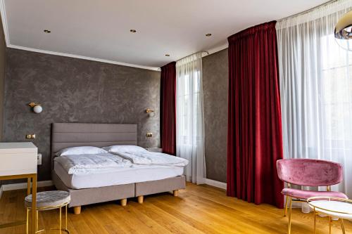 En eller flere senge i et værelse på Rosso Aparthotel