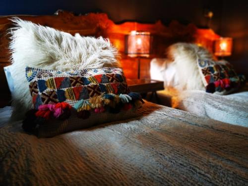 a bed with two pillows on top of it at Drumdelgie Cottages in Huntly