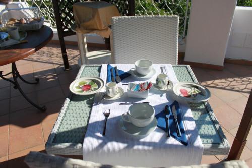 a table with a plate of food on it at Villa Marinella in Ischia