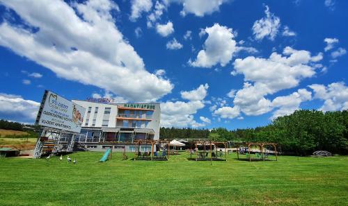a park with playground equipment in front of a building at Vu-Dent Apartments in Gevgelija