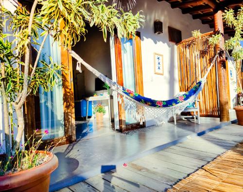 a hammock in the middle of a room with plants at VILA TRANCOSEAR in Trancoso