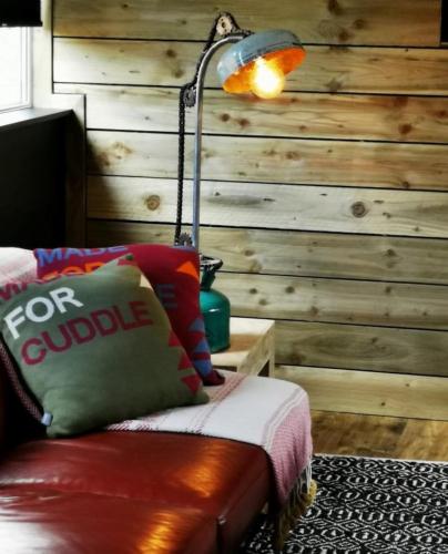 a lamp sitting on a couch in a room at Drumdelgie Cottages in Huntly