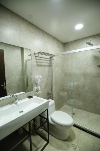 a bathroom with a toilet and a sink and a shower at Bakuriani Crystal Loft 412 in Bakuriani