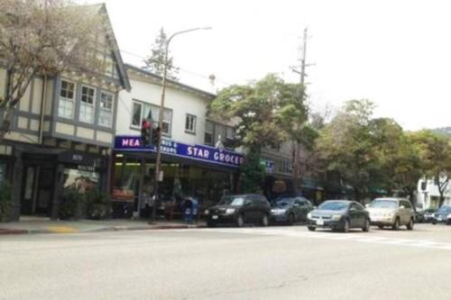 a city street with cars parked in front of a store at Elegant Spacious Private Studio ~ Upscale Berkeley in Berkeley