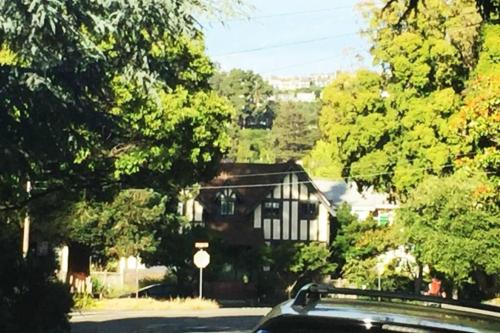 a car parked in front of a house with trees at Elegant Spacious Private Studio ~ Upscale Berkeley in Berkeley
