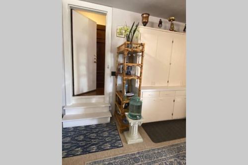 a bathroom with white cabinets and a mirror at Elegant Spacious Private Studio ~ Upscale Berkeley in Berkeley