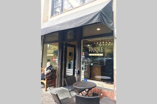 a table and chairs in front of a store at Elegant Spacious Private Studio ~ Upscale Berkeley in Berkeley