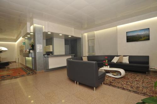 a living room with a couch and a table at Hotel Astoria in Fermo