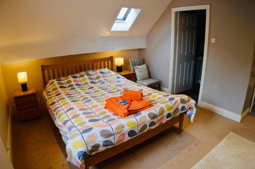 a bedroom with a bed and a chair and a window at Stanton House Annex in Bakewell