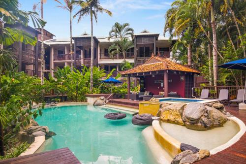a pool at a resort with a large building at Hibiscus Resort 10 ~ Fabulous location in Port Douglas