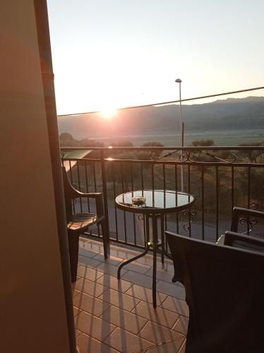 a balcony with a table and a view of the sunset at B&B Albachiara in Senise