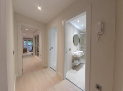 a hallway of a home with a mirror at Apartamentos Palacio de Yolanda in Zamora