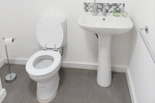 a white bathroom with a toilet and a sink at Spacious one bedroom family apartment -non smoker in Wakefield