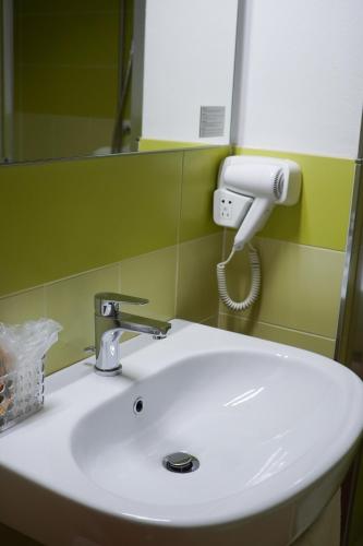 a white sink in a bathroom with a mirror at Dimora Toscana in Treggiaia