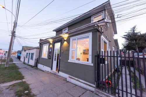 a black building with a window and a fence at HOSTAL BOUTIQUE TERRA ANTARCTICA in Punta Arenas