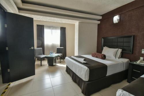 Cama o camas de una habitación en Hotel Portonovo Plaza Centro