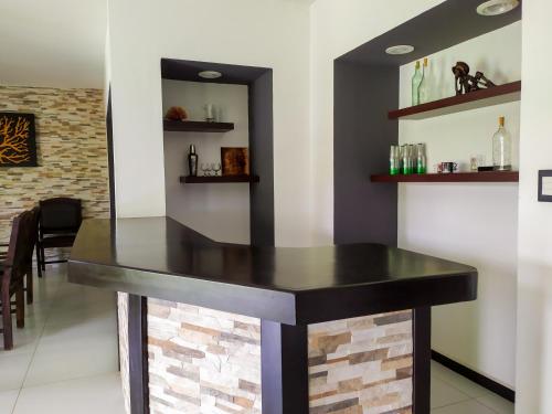 a bar in a restaurant with a black counter at Villas Montserrat Wellness Center in Guadalupe