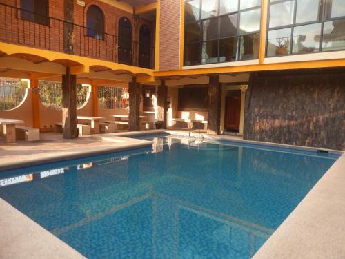 a swimming pool in the middle of a building at Lizmar in Los Ayala