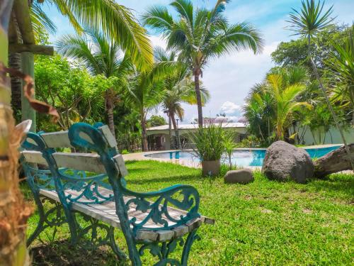 a park bench sitting next to a swimming pool at Villas Montserrat Wellness Center in Guadalupe