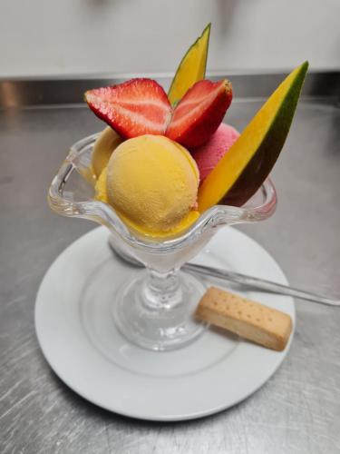 a glass bowl of fruit with strawberries and a cork at The Pelican Inn in Devizes