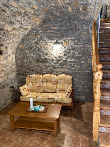 a living room with a couch and a table at Casa Encuentra, en el Pirineo al lado de Ainsa in El Pueyo de Araguás