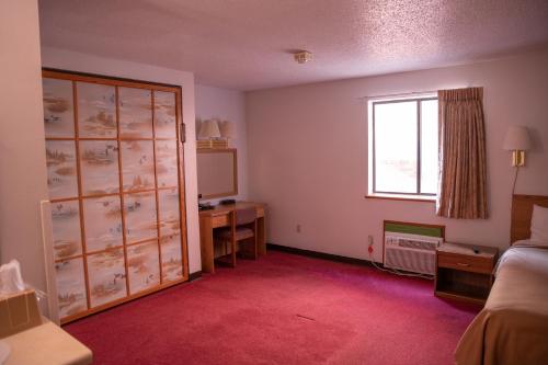 Ένα ή περισσότερα κρεβάτια σε δωμάτιο στο Wagner Lakeside Motel