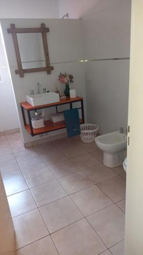 a bathroom with a sink and a toilet at UBUNTU in Concepción del Uruguay