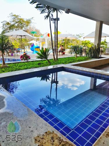 a pool at a resort with a playground at Park Veredas - Apto 526 - Flat Service in Rio Quente