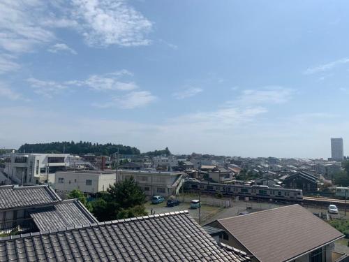 a view of a city with houses and buildings at ホテルノマド日立 in Hitachi
