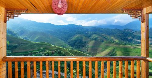 a balcony with a view of the mountains at Longji Terrace La vie Inn in Longsheng