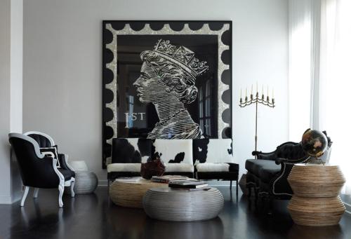a living room with a black and white painting of a woman at Bungalow Hotel in Long Branch