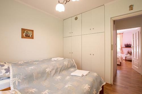 a bedroom with a bed and a dresser at Całoroczny dom wakacyjny in Stęszewko