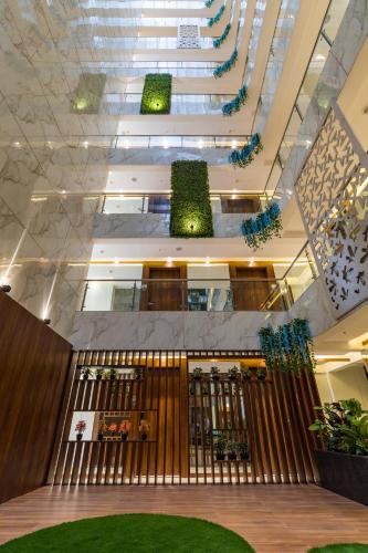 a lobby of a building with stairs and plants at AR Suites Jewels Royale - Koregaon Park NX in Pune