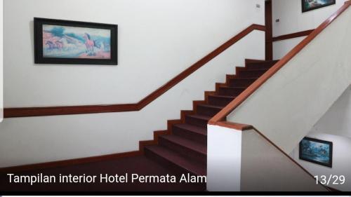 a staircase in a house with a picture on the wall at Hotel permata alam in Bogor