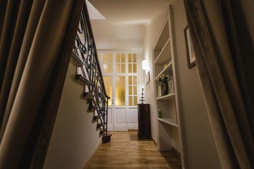 a hallway with a stairway leading to a window at Hortensia Garden in Macerata