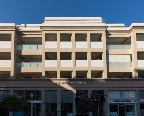 an office building with the front of the building at Rhodes Central Suite in Rhodes Town