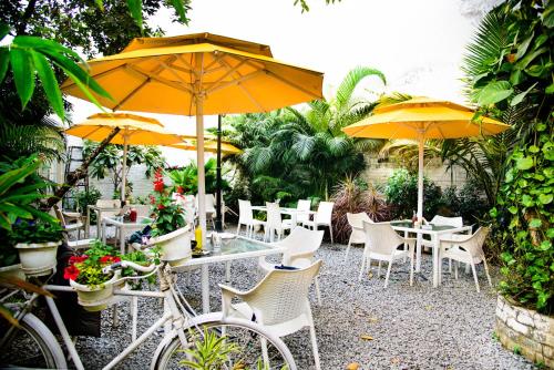 a group of tables and chairs with yellow umbrellas at Stay Banaras - A Boutique Hotel in Varanasi