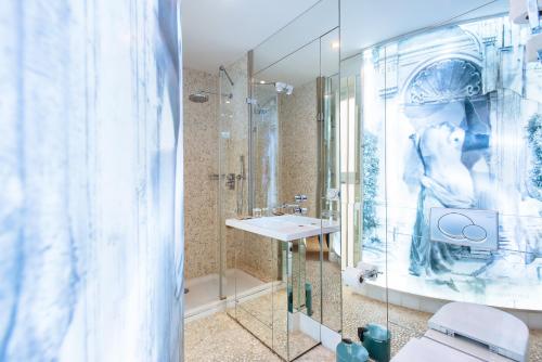 a bathroom with a shower and a sink and a toilet at Maestranza Boutique in Seville