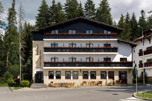 a building with balconies on the side of it at Manor Ski Hotel in Predeal