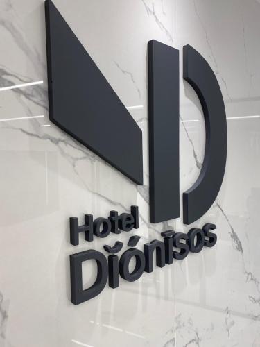 a sign for a hotel dholis sign on a wall at Dionisos Hotel in Larisa