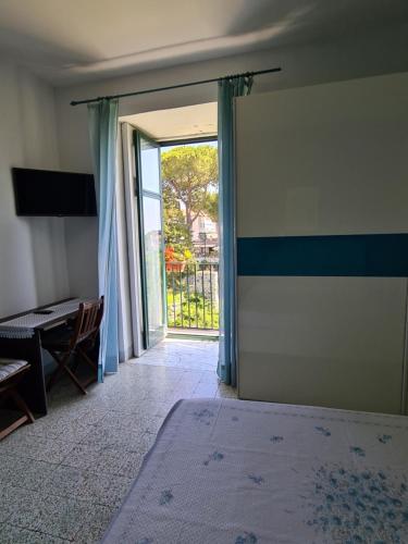 an empty room with a sliding glass door with a table at Palazzo Della Marra in Ravello