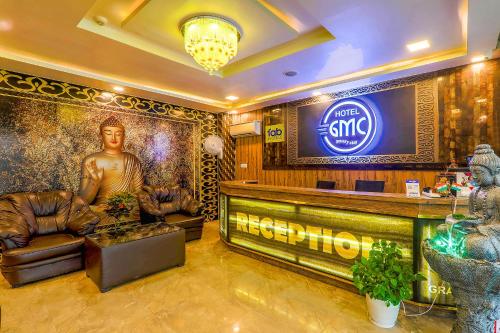 a lobby with a bar with a large screen at FabHotel GMC Grand in Lucknow