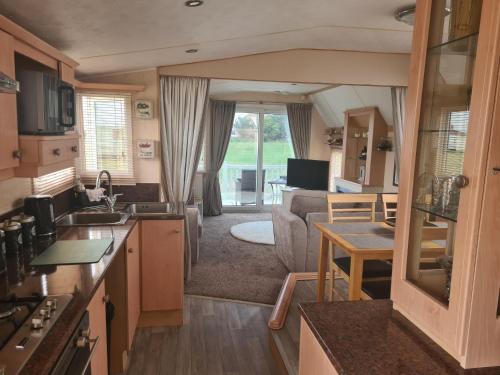a kitchen and living room with a caravan at 6 Berth The Chase Ingoldmells Concept in Ingoldmells