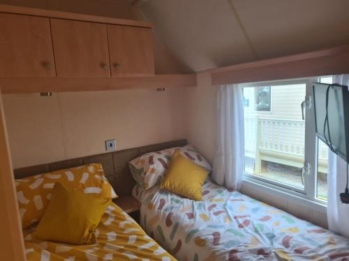 a small room with a couch and a window at 6 Berth The Chase Ingoldmells Concept in Ingoldmells
