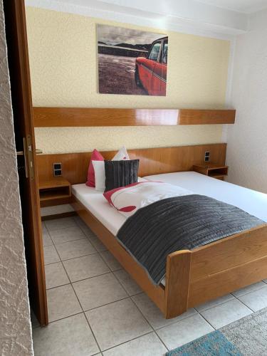 a bedroom with a large bed with a wooden frame at Hotel Zur Aue in Wesel
