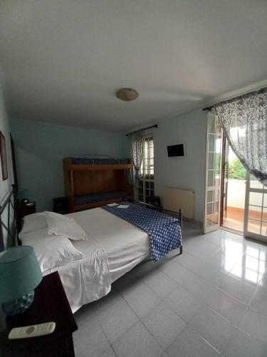 a bedroom with a bed and a large window at Il Grifo in Sabaudia